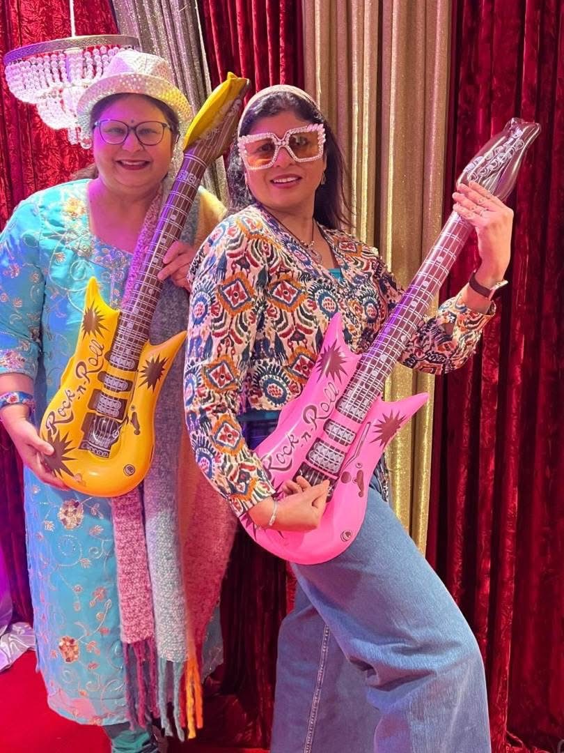 Guests posing with playful guitars