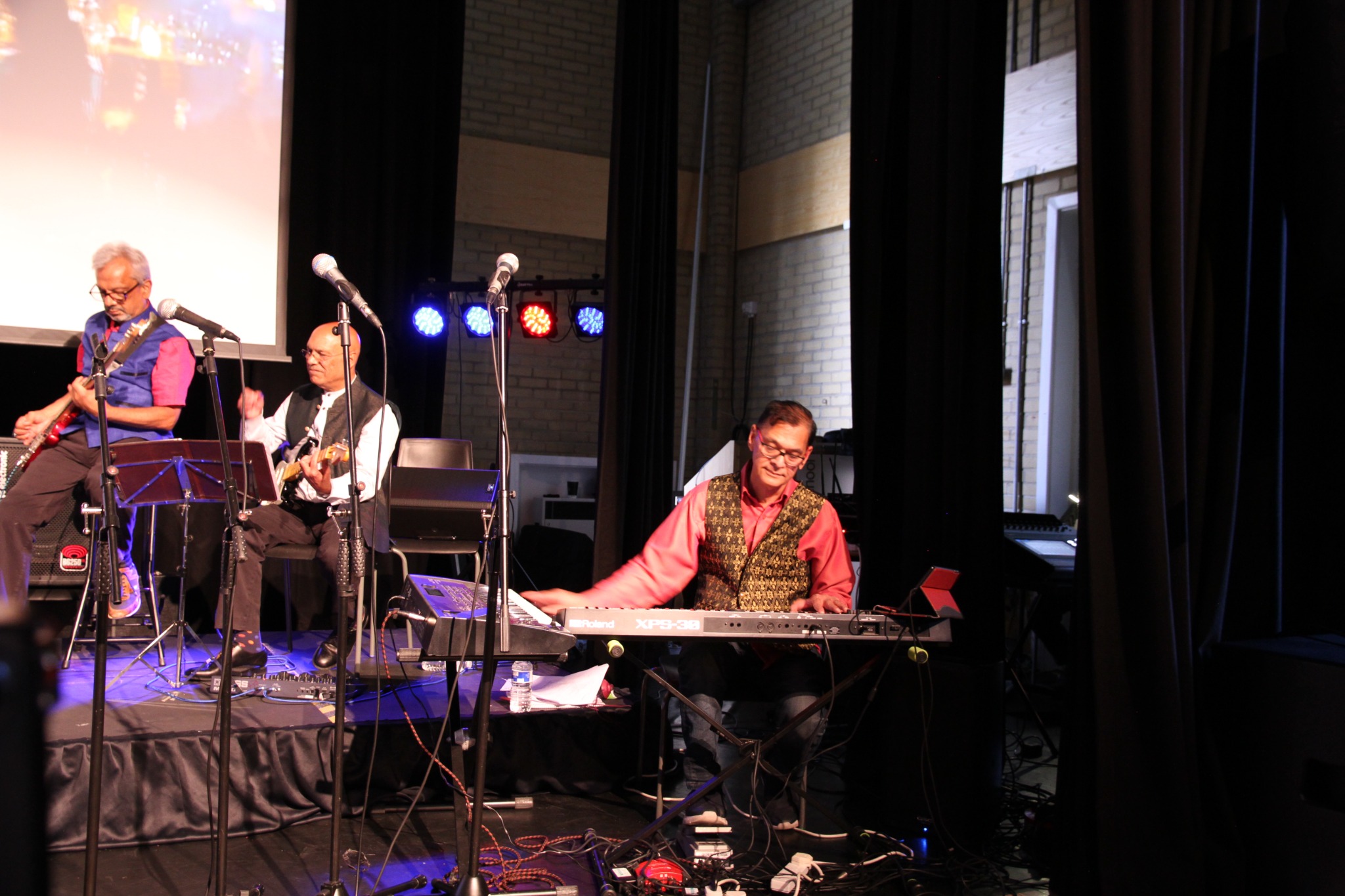 Keyboard and guitar players performing on stage